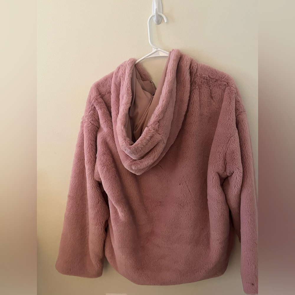 Furry jacket . Pink . Forever 21. With a hoodie and pockets . New.
